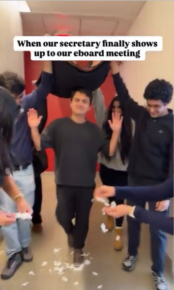 Reel still of executive board members posing in a hallway